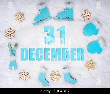 December 31st. Sports set with blue wooden skates, skis, sledges and snowflakes and a calendar date. Day 31 of month. Winter sports concept. Winter mo Stock Photo