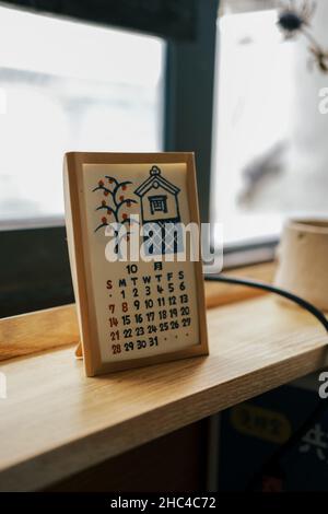 A hand-drawn calendar on the windowsill, translating the text shown in the picture: October Stock Photo