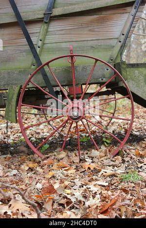 Bright red painted covered wagon wheel. Stock Photo