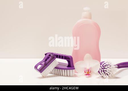 Bottle of dishwashing liquid and brushes on white background. Stock Photo