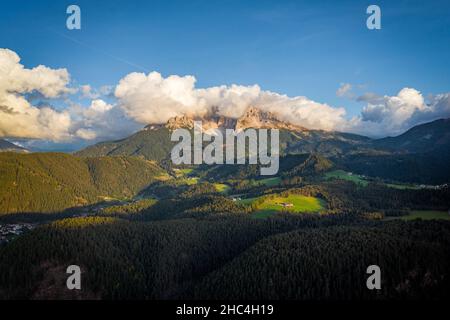 aerial view on cloudy dolomites mountains latemar during sunny day Stock Photo