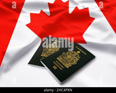 Passports of Canada, Canadian passport on the top of satin flag Stock Photo