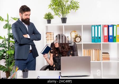 Work task order. Boss set task to secretary. Office work. Man and woman at workplace Stock Photo