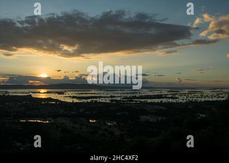 View from on top of Mandalay Hill, at sunset during the monsoon season. City of Mandalay, Myanmar Stock Photo