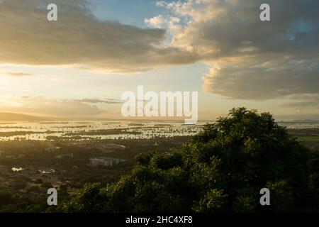 View from on top of Mandalay Hill, at sunset during the monsoon season. City of Mandalay, Myanmar Stock Photo