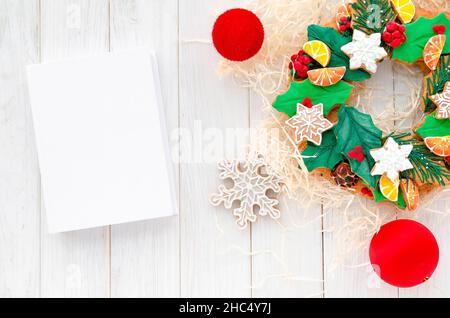 Christmas Concept. gingerbread in the form of a Christmas wreath lies on a white wooden background Stock Photo