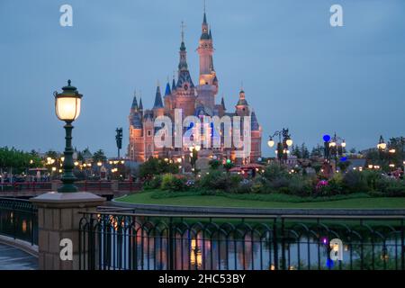 SHANGHAI, CHINA - Sep 21, 2017: Shanghai Disneyland Castle in the evening with night lights and river background Stock Photo