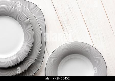 For home and restaurant. A classic set of porcelain plates of different shapes and sizes Stock Photo