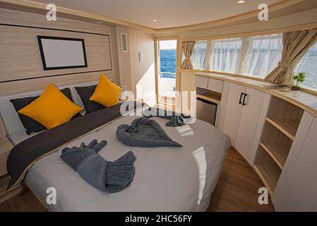 Interior of large suite cabin bedroom on luxury sailing yacht with ...