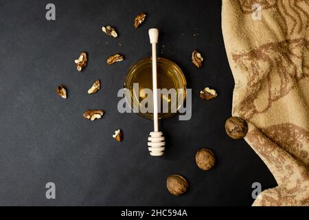 Top view of honey and walnuts on a black background Stock Photo