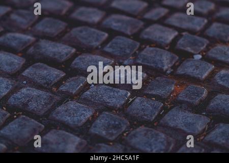 Closeup shot of details on a cobblestone road Stock Photo