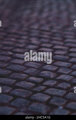 Vertical closeup shot of details on a cobblestone road Stock Photo
