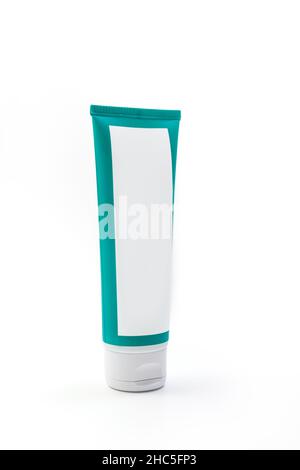 Cosmetic cream green tube. Sskincare cosmetic package. Plastic toothpaste tube. Product in green tubeisolated on white background. Clipping path inclu Stock Photo