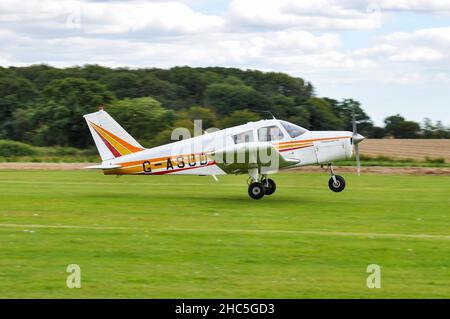 Piper PA-28-180 Cherokee B light aircraft plane G-ASUD taking part in a spot landing event at Elmsett Airfield. Pilot landing accuracy competition Stock Photo