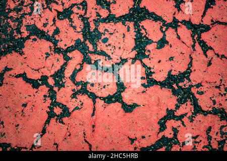 Old cracked red stone textured wall surface Stock Photo