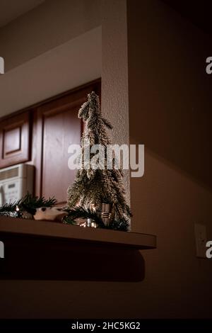 Small Christmas tree in the home on pedestal Stock Photo