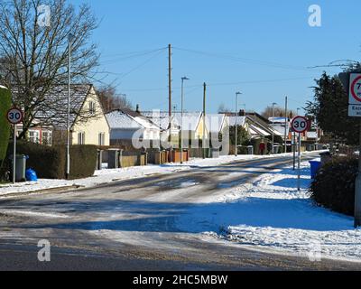 Row of bungalows along Tytton Lane East on a snow covered winter's day in Wyberton Lincolnshire Stock Photo