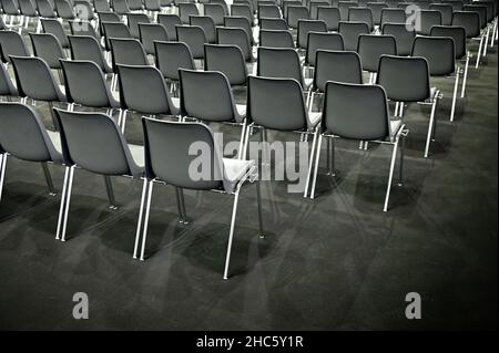 Gray empty audience seats arranged in rows Stock Photo