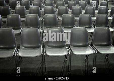 Gray empty audience seats arranged in rows Stock Photo