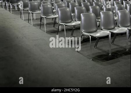 Gray empty audience seats arranged in rows Stock Photo