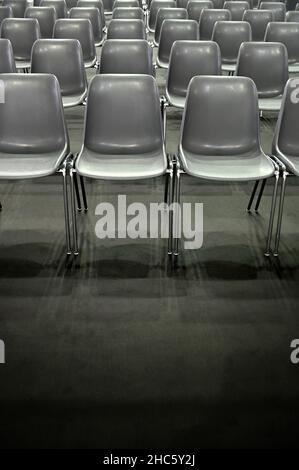 Gray empty audience seats arranged in rows Stock Photo