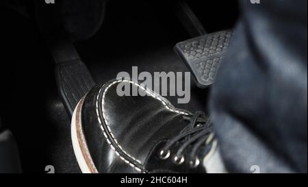 Accelerator and breaking pedal in a car. Close up the foot pressing foot  pedal of a car to drive ahead. Driver driving the car by pushing accelerator  Stock Photo - Alamy