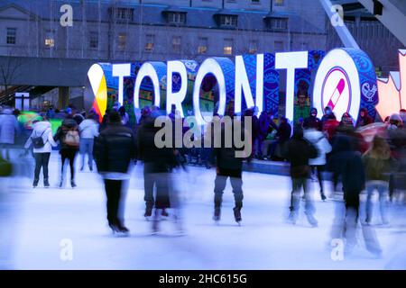 Toronto, December 24, 2021 -  Christmas Eve Skating at Nathan Phillips Square Stock Photo