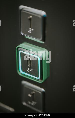 Close up shot of the elevator buttons with green lights Stock Photo