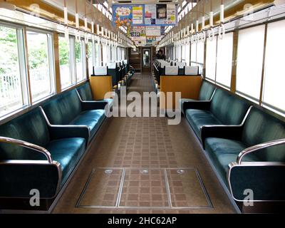 Interior design local train and japanese people and foreign travelers passenger inside use service journey work and travel by railway in Arashiyama st Stock Photo