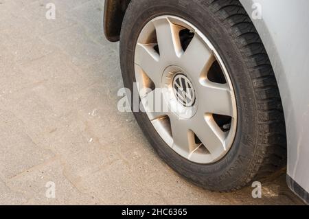 Closeup of a dirty wheel of a parked car with a Volkswagen company logo Stock Photo