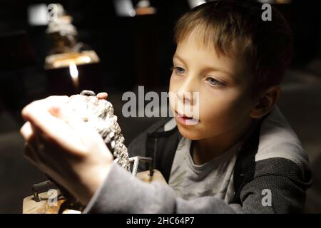 Boy studying natural mineral in Geological Museum Stock Photo