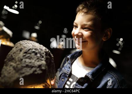 Child studying natural mineral in Geological Museum Stock Photo