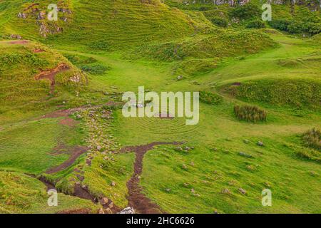 Fairy Glen on the Isle of Skye in Scotland. Green lush meadows with circles on travel. Small hills with paths. Beaten path with earth in summer. Few s Stock Photo