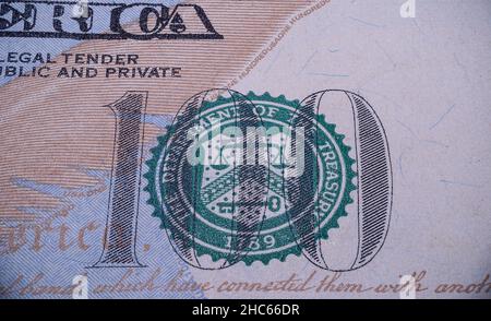 Closeup shot of the 100 Sign and the Green seal on the 100$ US Dollars Bill Stock Photo