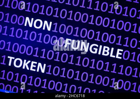 Close up of Binary codes on screen and NFT word in the middle - Non Fungible Token - Smart Contract and Digital Ownership Stock Photo