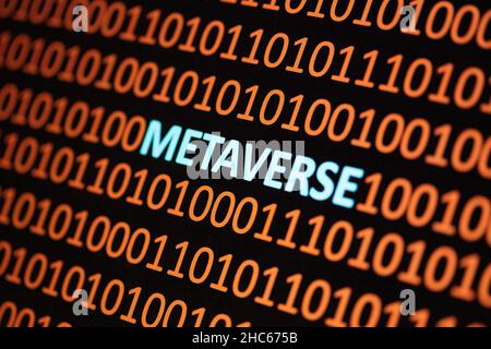Close up of Binary codes on screen and Metaverse word in the middle - New Decentralized Internet - Smart Contract and Crypto Currency Stock Photo