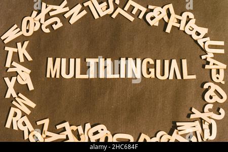 Multilingual word from wooden blocks of Alphabet letters. Table Top View. Stock Photo
