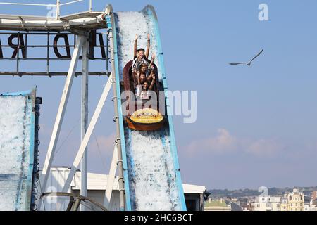 BRIGHTON, GREAT BRITAIN - SEPTEMBER 16, 2014: Unidentified visitors have fun at the water attractions at the Brighton Pier. Stock Photo