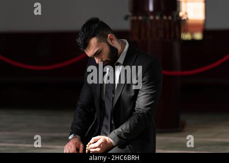 Attractive Man Making Traditional Prayer to God Allah in the Mosque Stock Photo