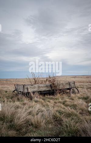 Abandoned woorden wagon in rural alberta Canada with cloudy skies Stock Photo