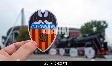 August 30, 2021, Valencia, Spain. The emblem of the football club Valencia CF against the background of a modern stadium. Stock Photo