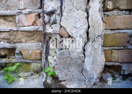 Damaged concrete pillar with rusty iron fittings Stock Photo