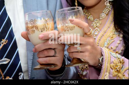 newlyweds Arabian in their hands cups of milk. Arab wedding tradition Stock Photo