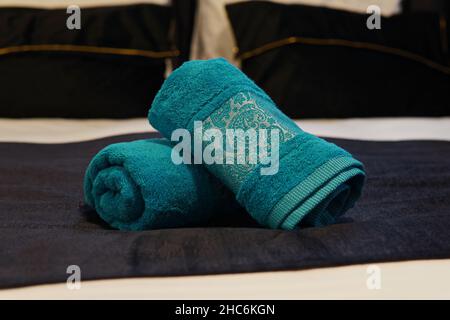 Closeup of the blue folded towels on the hotel bed Stock Photo