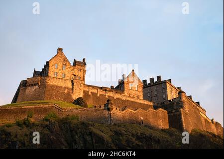 Edinburgh, Scotland- Nov 21, 2021:  The light of the setting sun illuminating Edinburgh Castle in Scotlland. Stock Photo