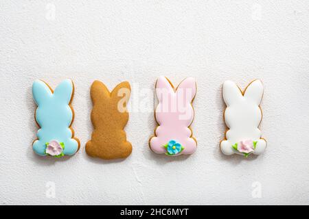 Overhead view of four Easter bunny cookies on light surface spring holiday Stock Photo