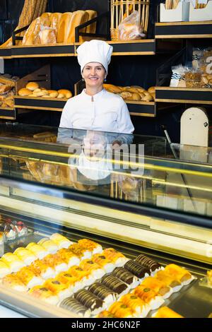 female baker offering fresh pastry Stock Photo