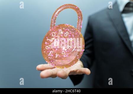 Male's hand holding an illustrated padlock - security concepts Stock Photo