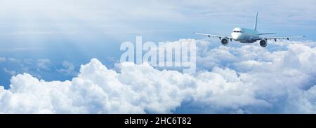 Jet plane in a blue cloudy sky. Panoramic composition in high resolution. Stock Photo