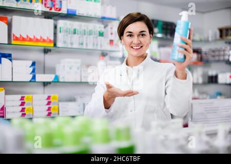Female pharmacist suggesting useful body care products Stock Photo